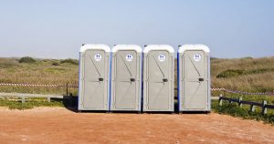 portable toilets outdoors near a hiking trail